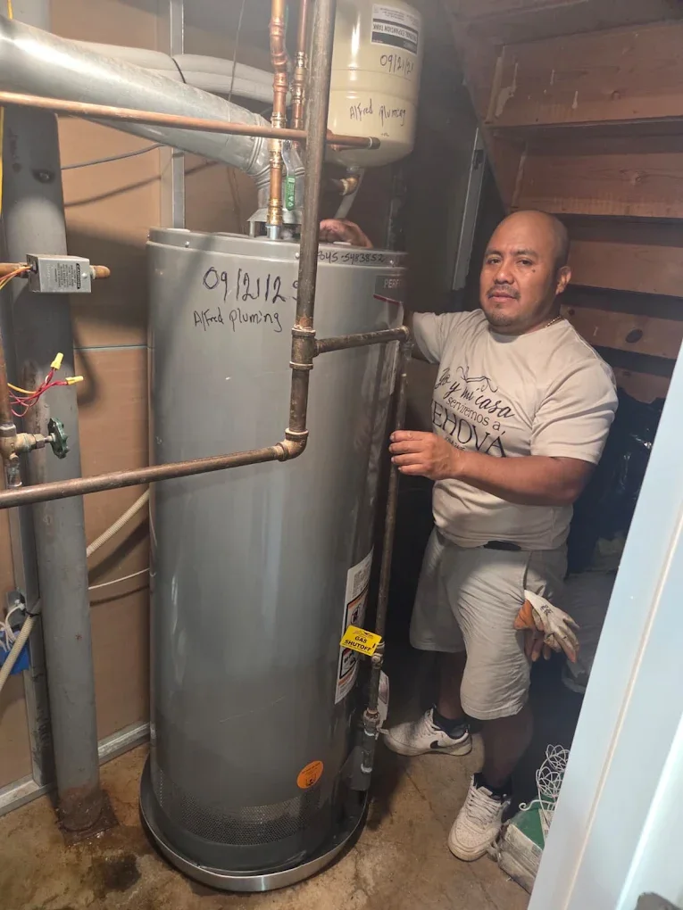 Alfredo Chub Xol, owner of Alfred Plumbing LLC, on a water heater installation job in New City, NY