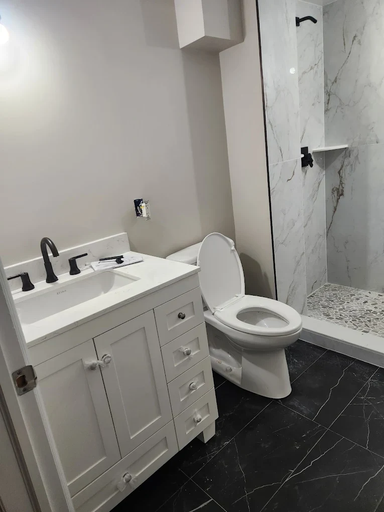 Finished bathroom remodel with new toilet, vanity and shower