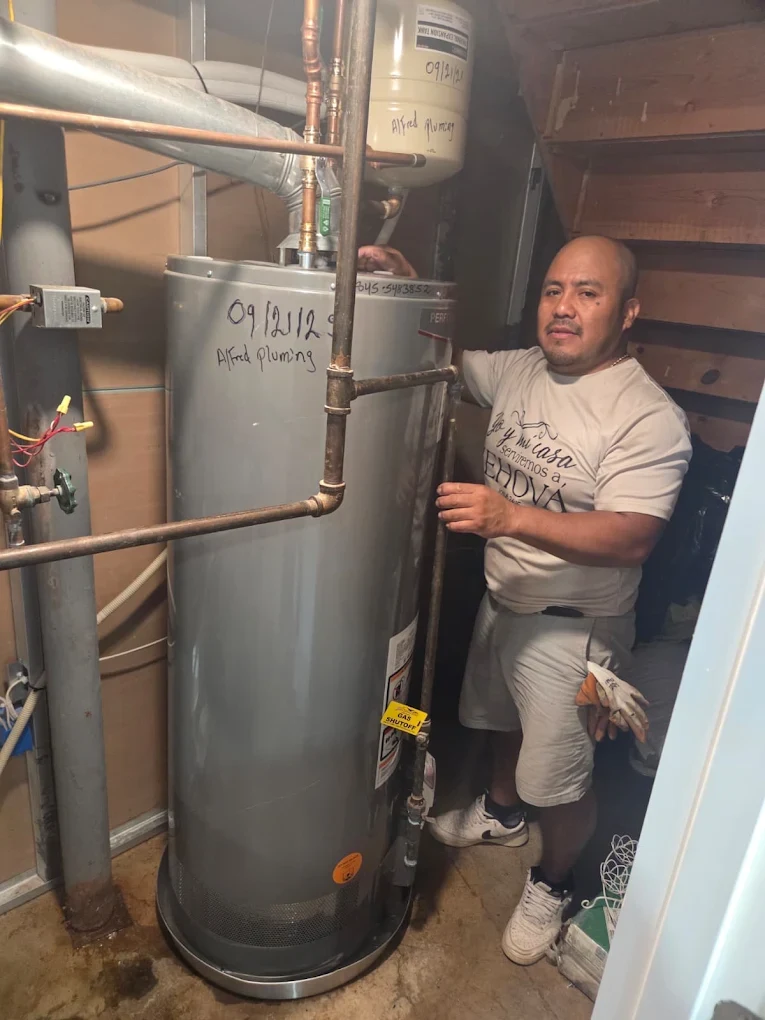 Alfredo Chub Xol of Alfred Plumbing LLC installing a water heater in New City, NY